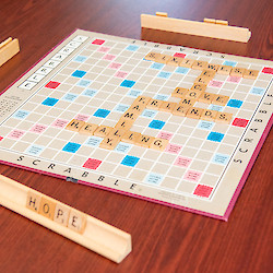 Scrabble board with "Hope", "Healing", "Family", "Friends", "Love", "Welcome", and "Sixty West" all written with scrabble pieces
